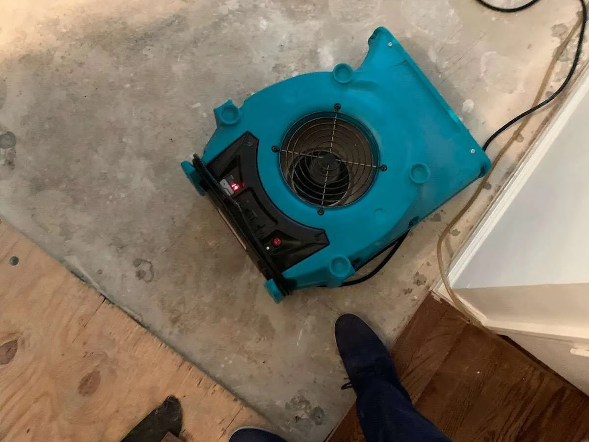 Air mover drying subfloor during Commercial Water Damage Restoration in Scottsbluff